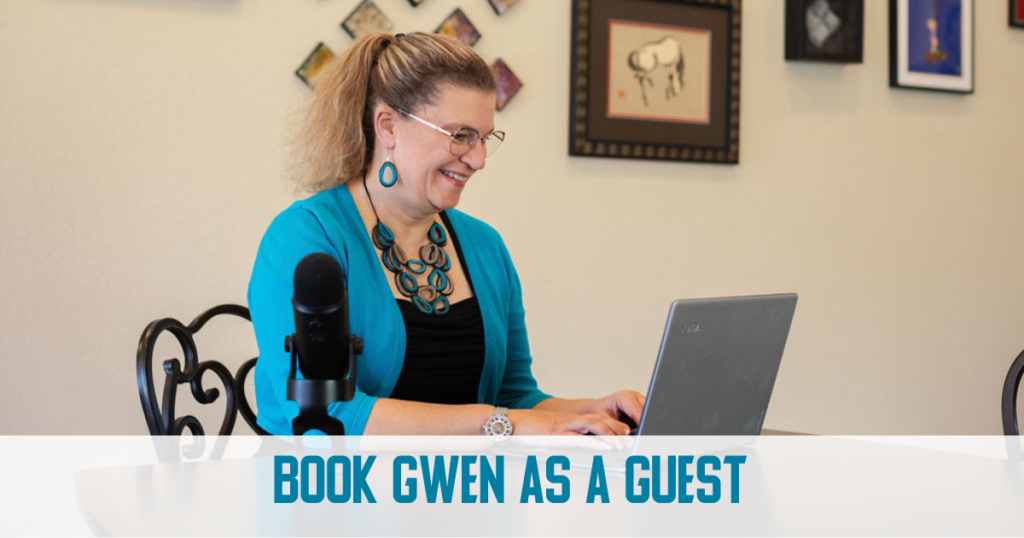 Gwen, with blonde hair pulled back in a functional ponytail, sits at a laptop, speaking to an online group. Gwne is wearing a black top with teal sweater, and matching chunky teal wooden necklace and earrings. You can see her desktop microphone next to her.